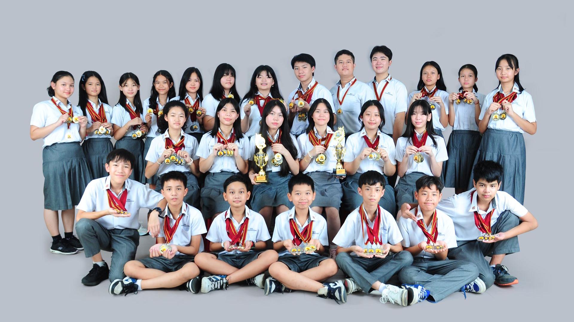 Students with medals and trophies
